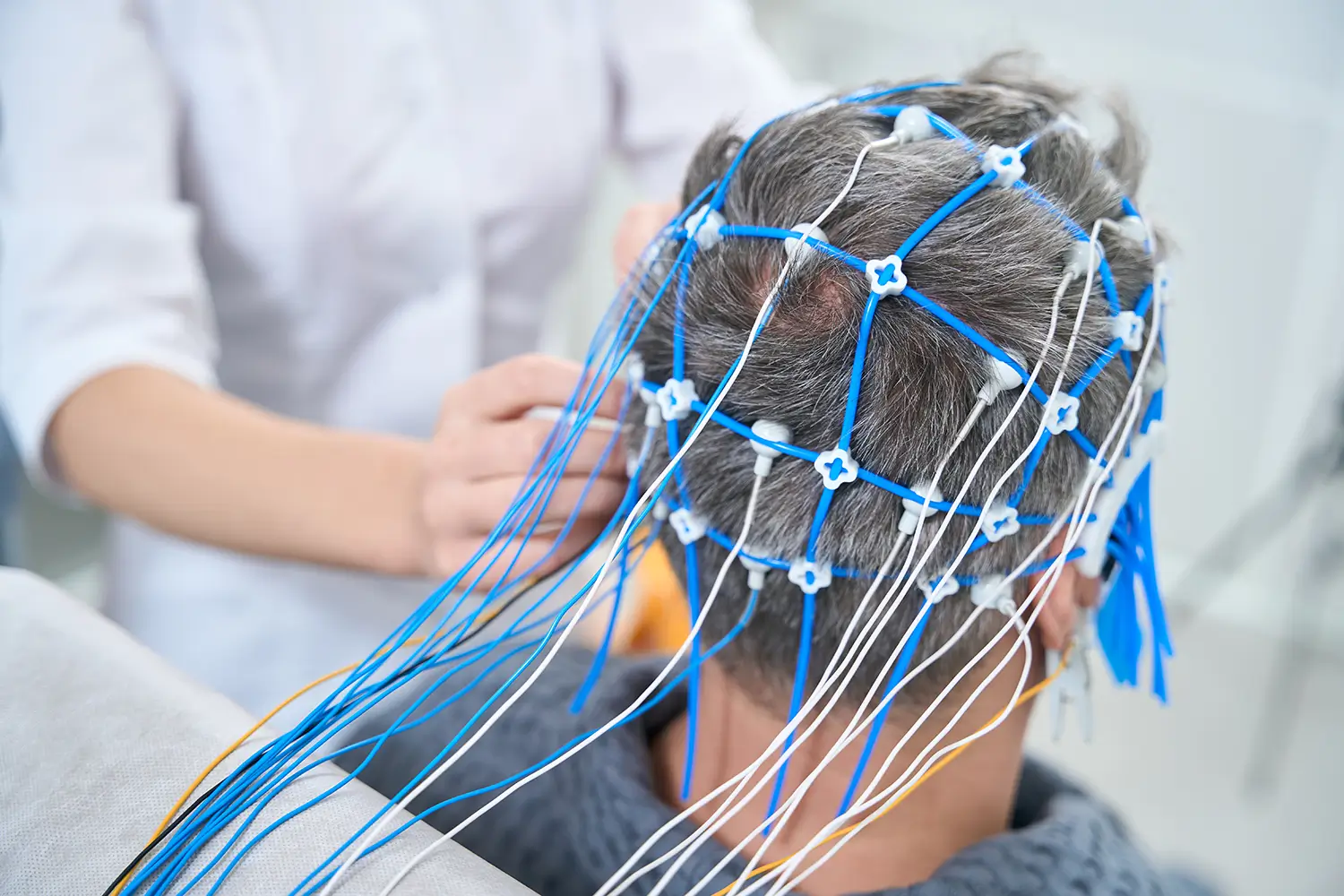Líder ejecutivo realizando una evaluación con un casco QEEG dentro del programa de rendimiento empresarial de Reygo Solutions